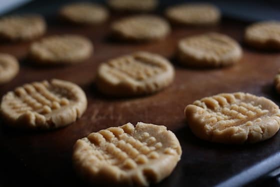 soft peanut butter cookies, unbaked on baking stone