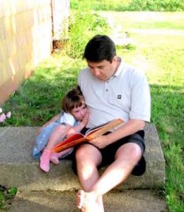 Daddy reading to little girl