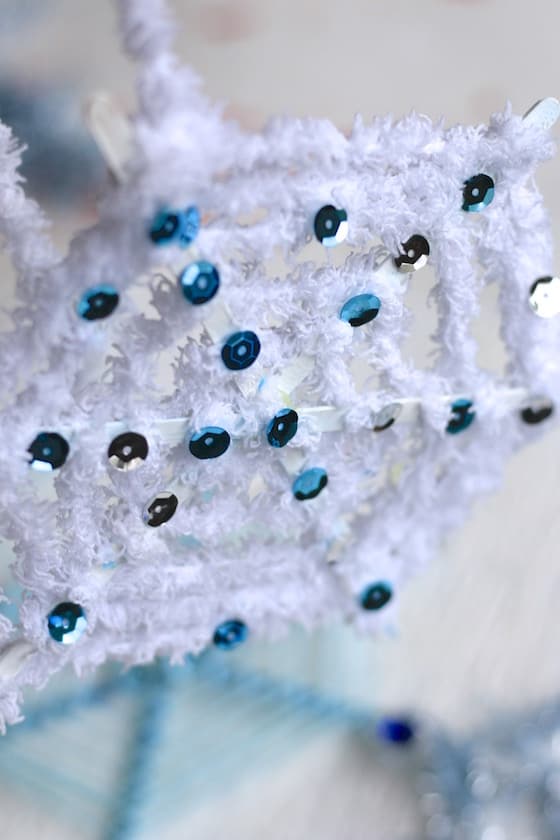 craft stick snowflake with starbucks stir sticks, white yarn and sequins
