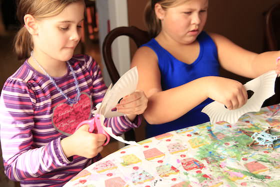 Girls cutting masks out of paper plates