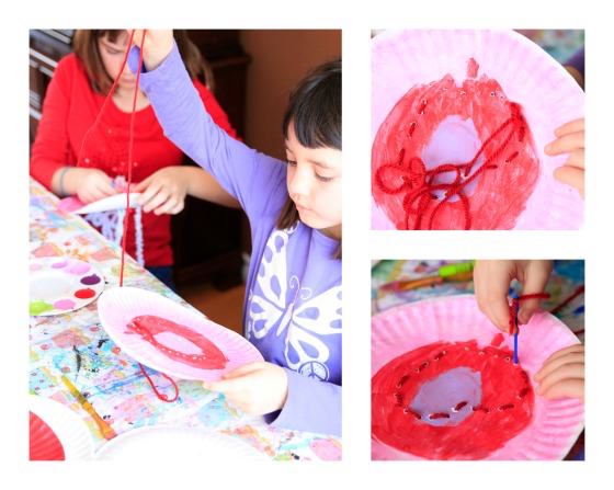 Kids lacing hearts on paper plates for Valentines craft