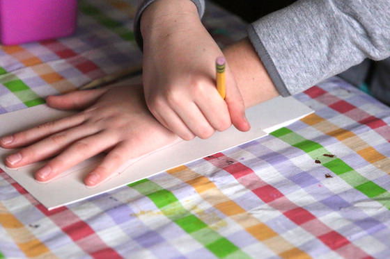 child tracing her hand