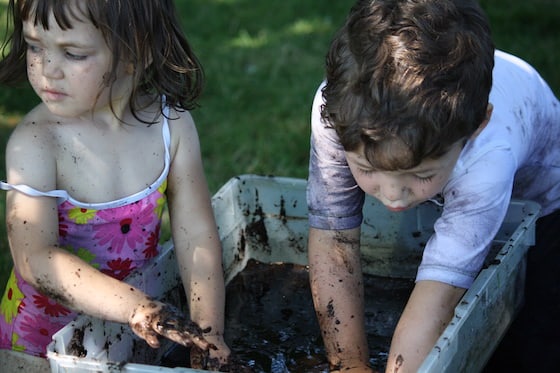 kids playing in a basin of mud