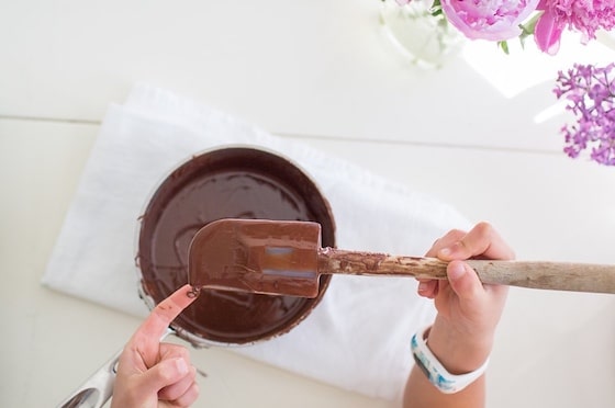 child stirring chocolate in double boiler