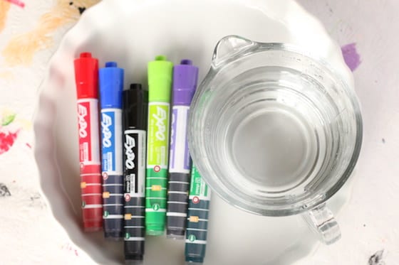 Supplies for dry erase and water experiment - dry erase markers, glass dish and water