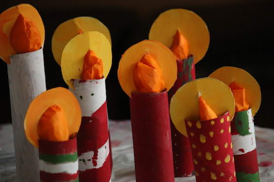 8 cardboard roll candles, different designs painted in red, green, white and yellow