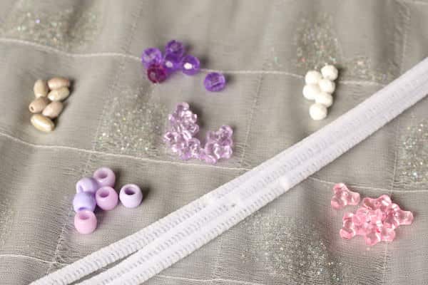 beads and pipe cleaners on silver tablecloth