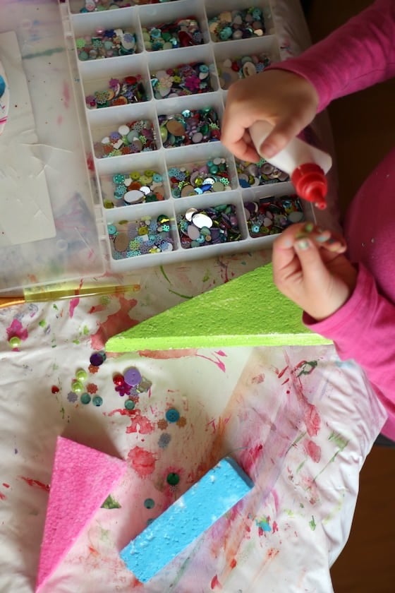 kids decorating christmas tree table toppers with gems