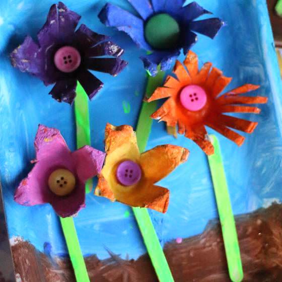 5 colourful painted egg carton flowers glued to painted styrofoam produce tray