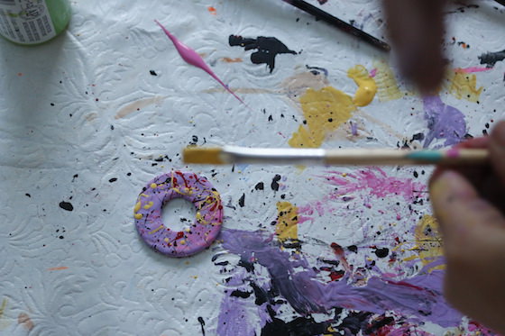 Child splatter painting a washer