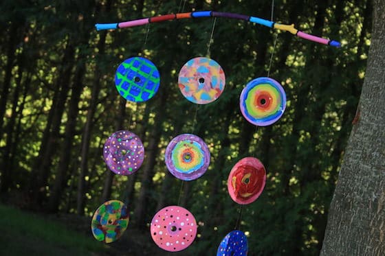 Painted CDs hung from colourful stick 