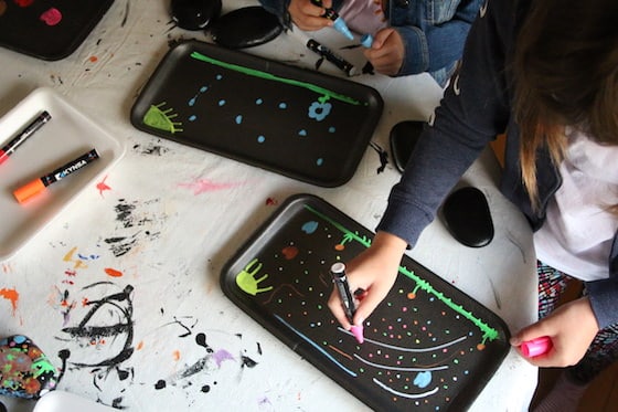 kids colouring on sytorofam produce trays