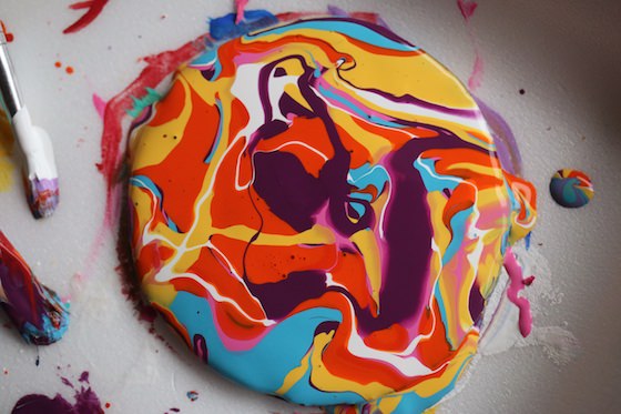 paint drizzled on cardboard circle