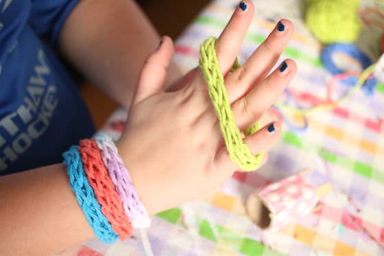 child modeling french knitted bracelets