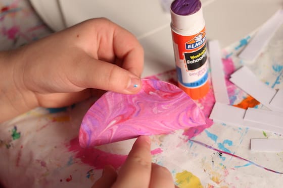 child's hands, paper circle and glue stick