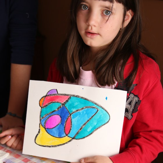 kid holding resist art painting