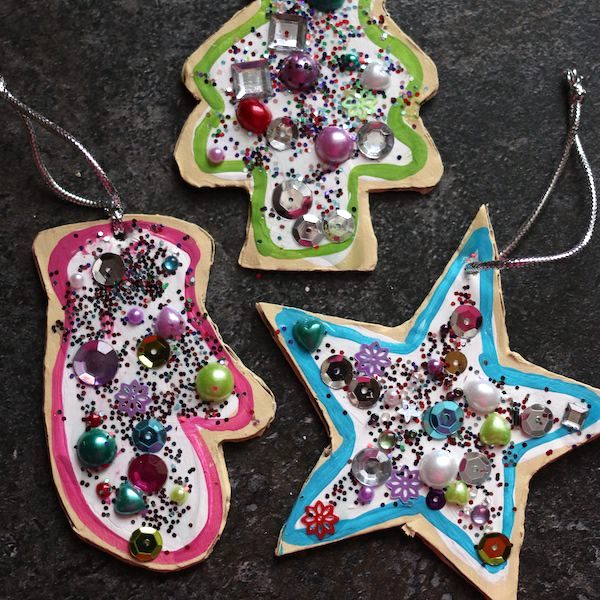 Square image sugar cookie ornaments on black countertop