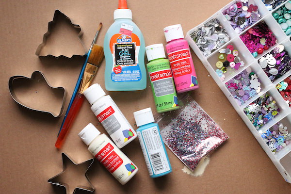 Cardboard, cookie cutters, paint, glue, glitter, sequins and craft gems