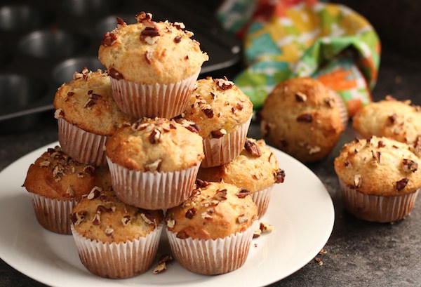 stack of banana mayo muffins topped with pecans 