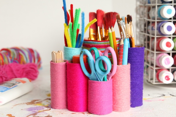 closeup toilet roll organizer wrapped with yarn and filled with supplies
