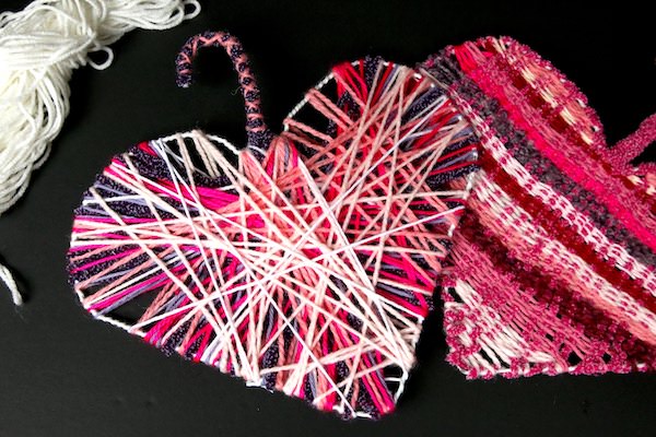 2 hearts weaved in pink on black background
