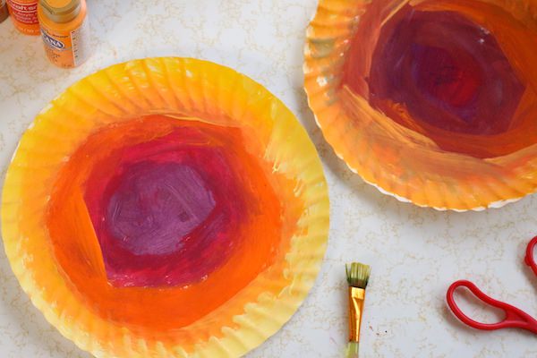 paper plates painted with rings of colour - yellow, orange, red, purple