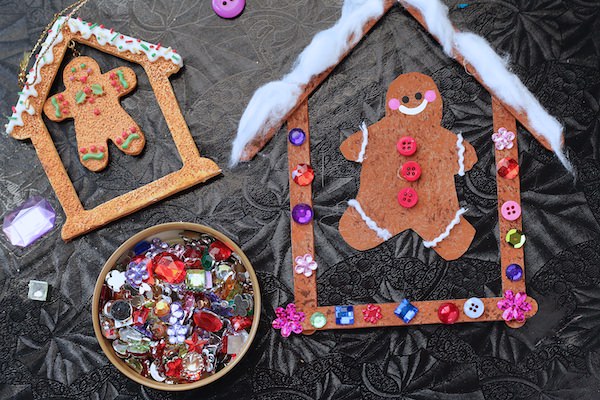 craft stick house and gingerbread cut out decorated with craft gems