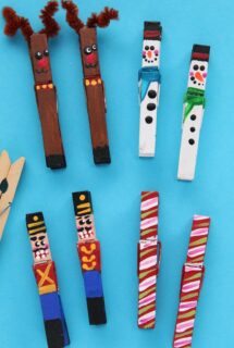 painted clothespin reindeer, snowmen, nutcrackers and candy canes on blue background