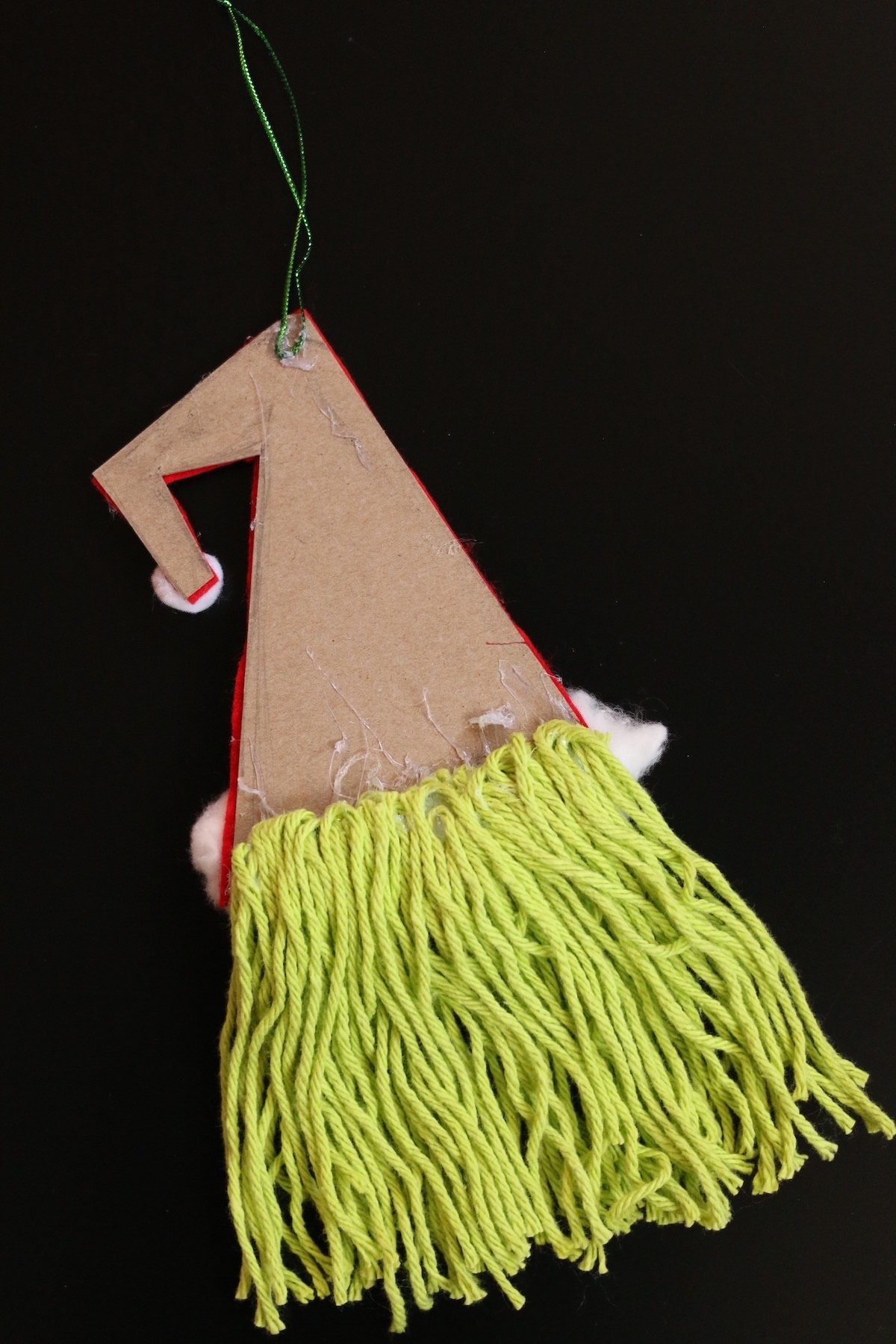 green yarn glued to back side of cardboard hat