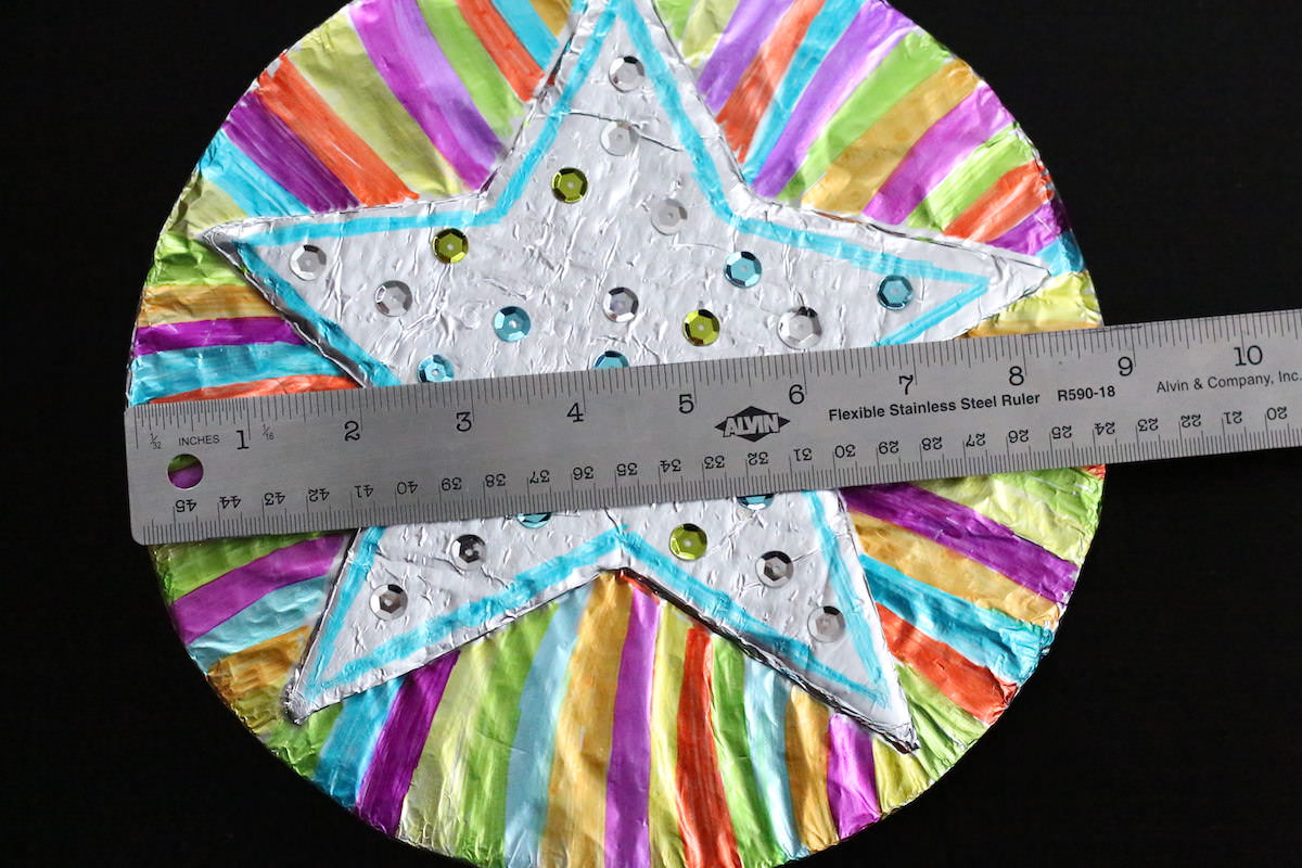 ruler placed on foil covered circle and star