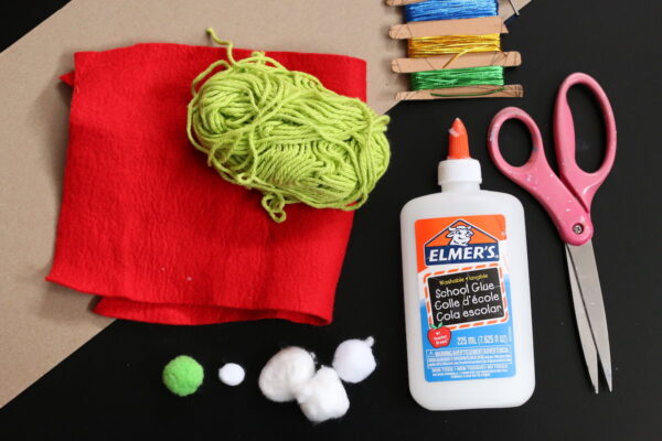 cardboard, red felt, green yarn, pom poms, glue and scissors