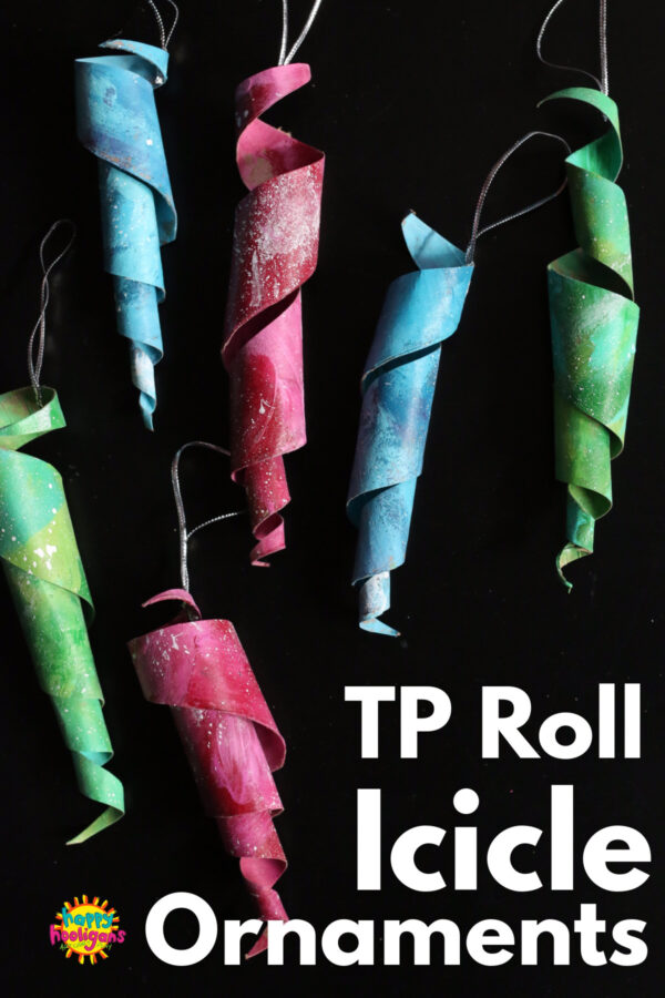 Colourful toilet paper roll icicle ornaments displayed vertically on black background