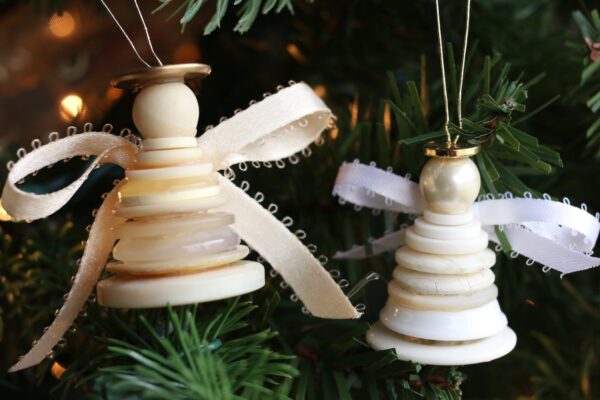 cream and white button angel ornaments on Christmas tree
