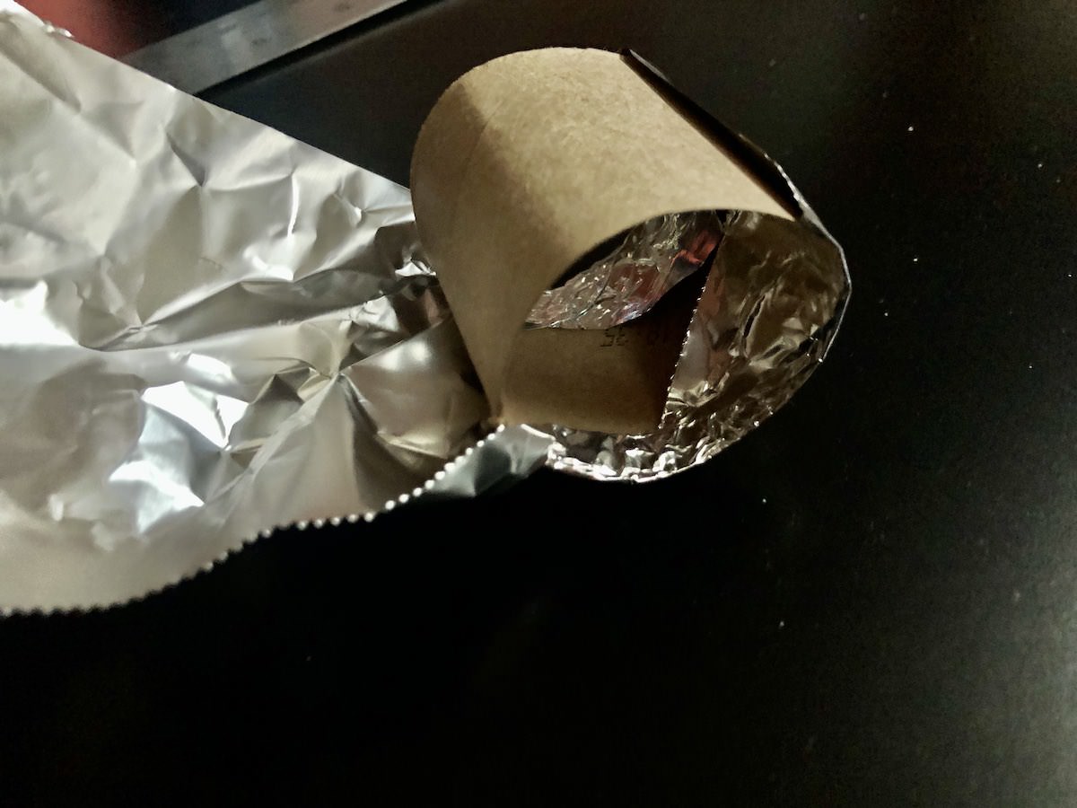 roilling foil around section of cardboard roll