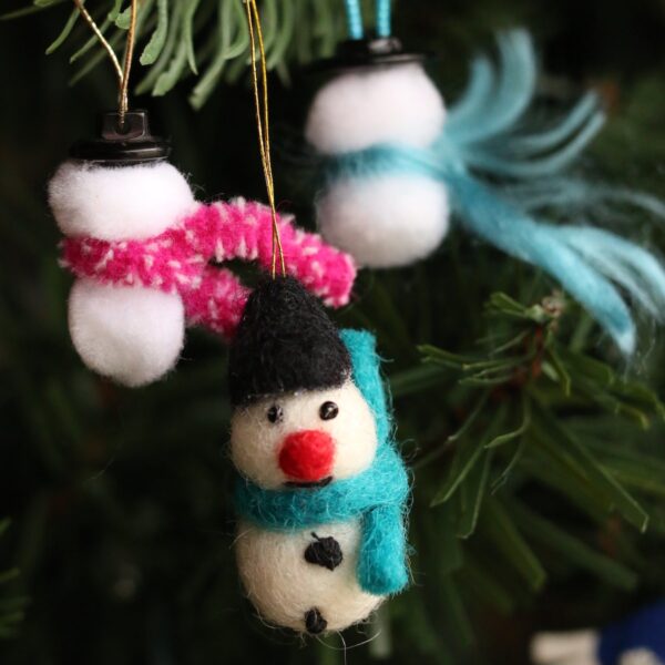 2 pom pom snowmen with yarn scarves plus one felted, store-bought snowman with french knots for eyes and buttons.